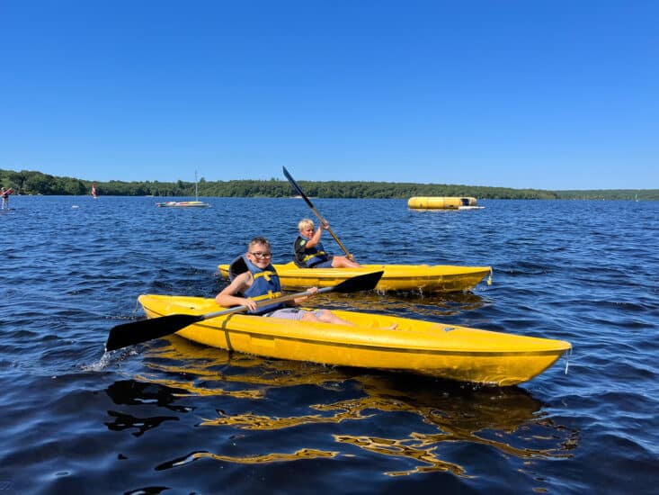 Children enjoying Kayaks on a pond during YMCA Summer Camp