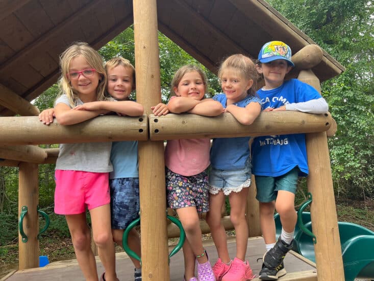 Children Playing Outside Ontop of a wooden structure at YMCA Ocean Community